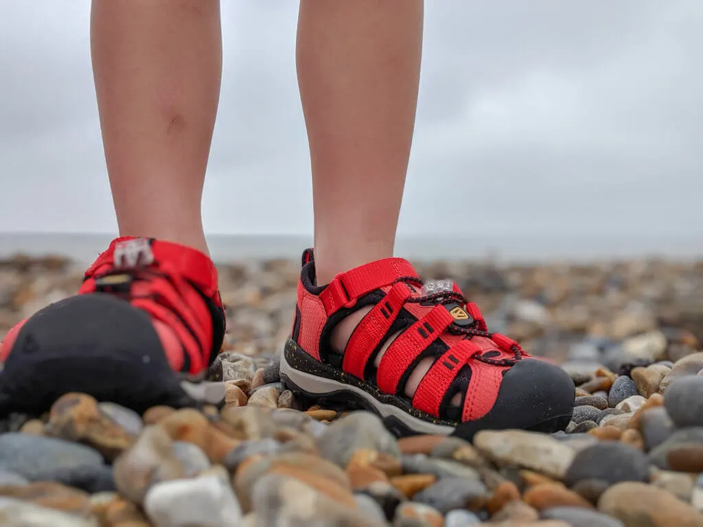 kids sandals on pebble beach