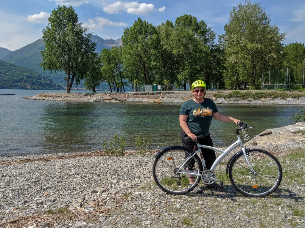 lady with bike by lake