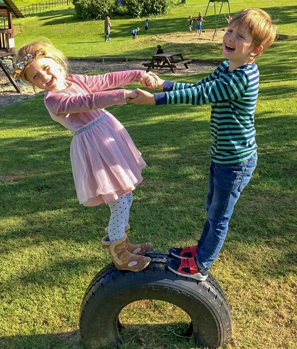 two children on a tyre