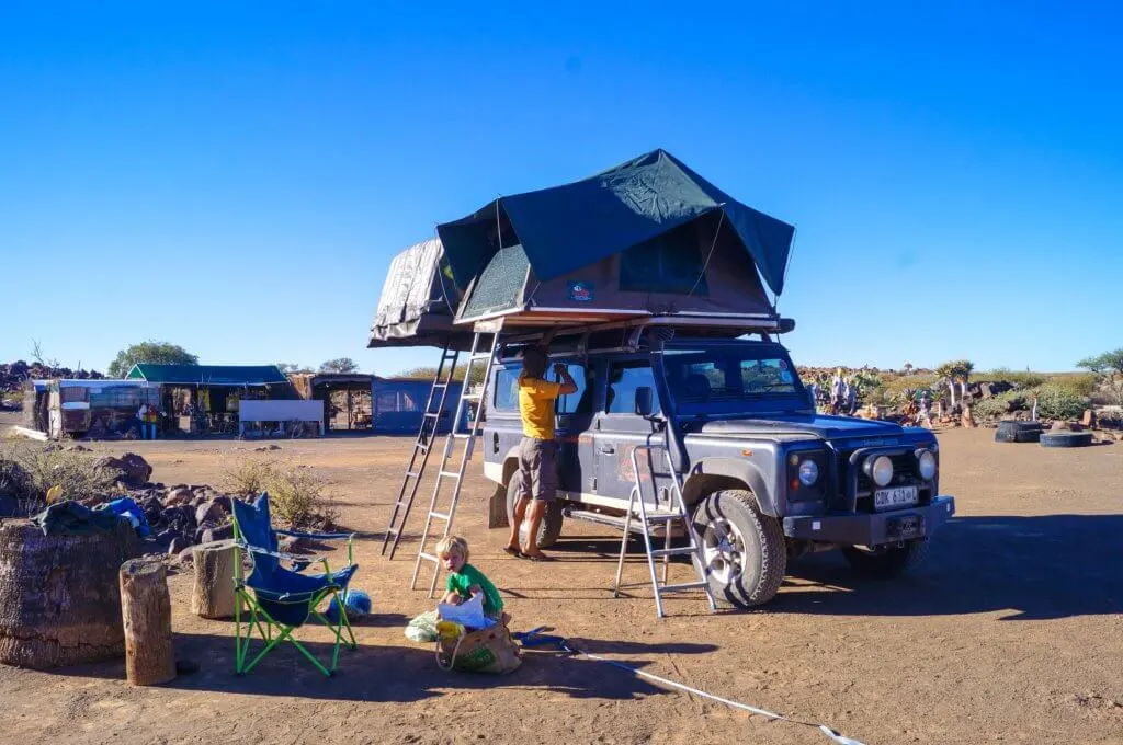 setting up camp. landrover with roof tents