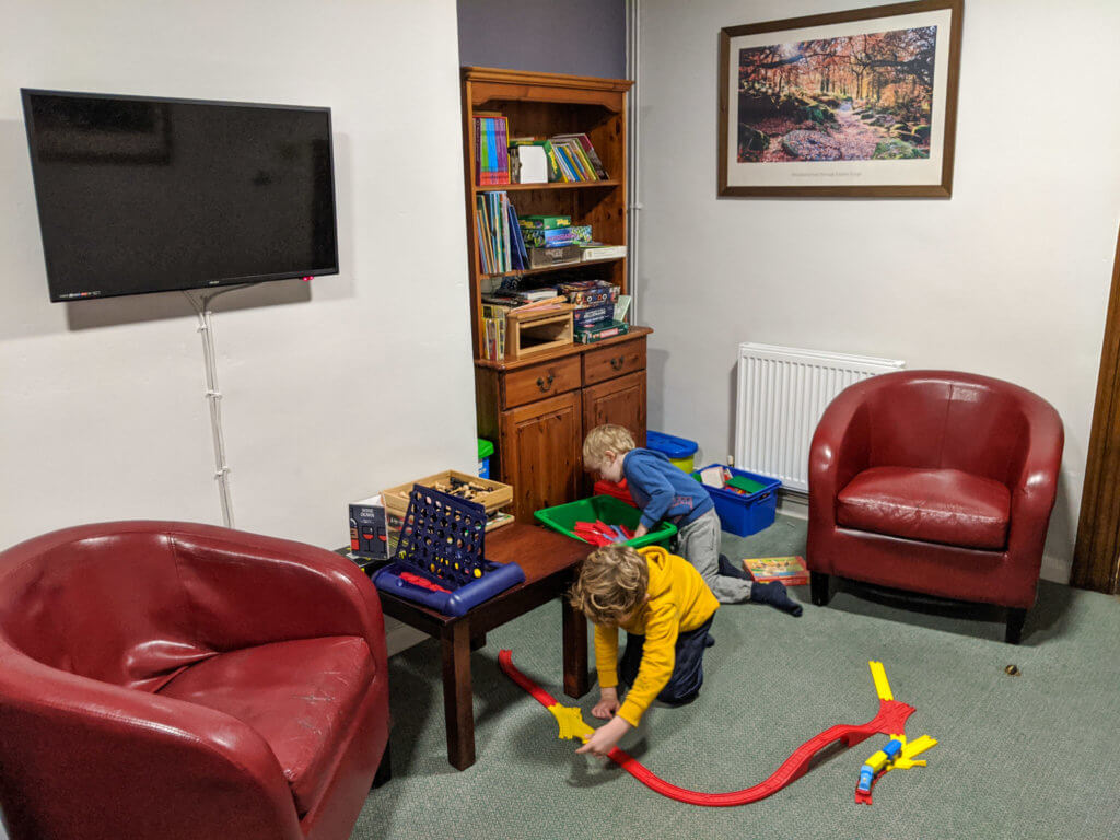 playing with train set in YHA Eyam lounge